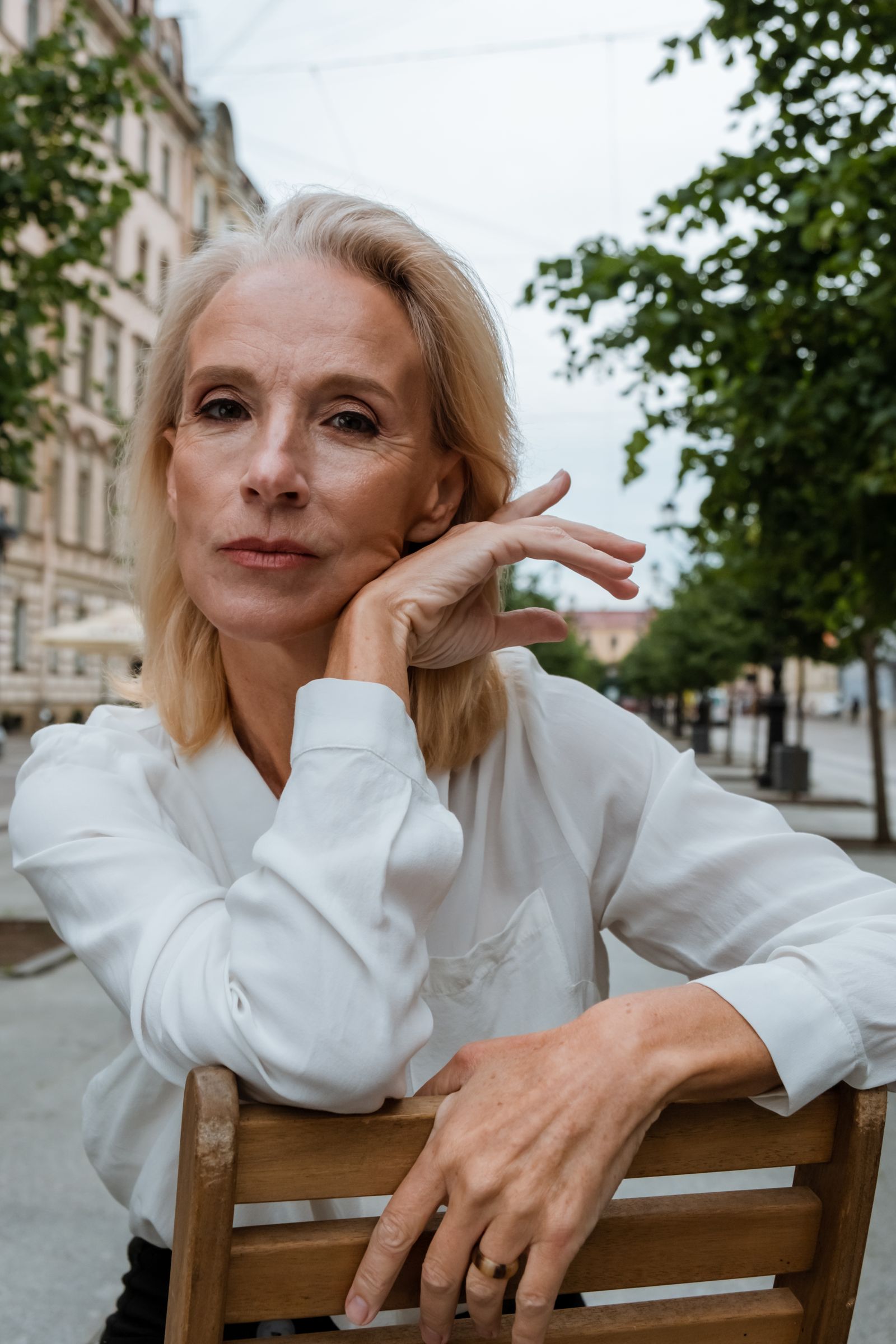 Confident woman in a white shirt in the city